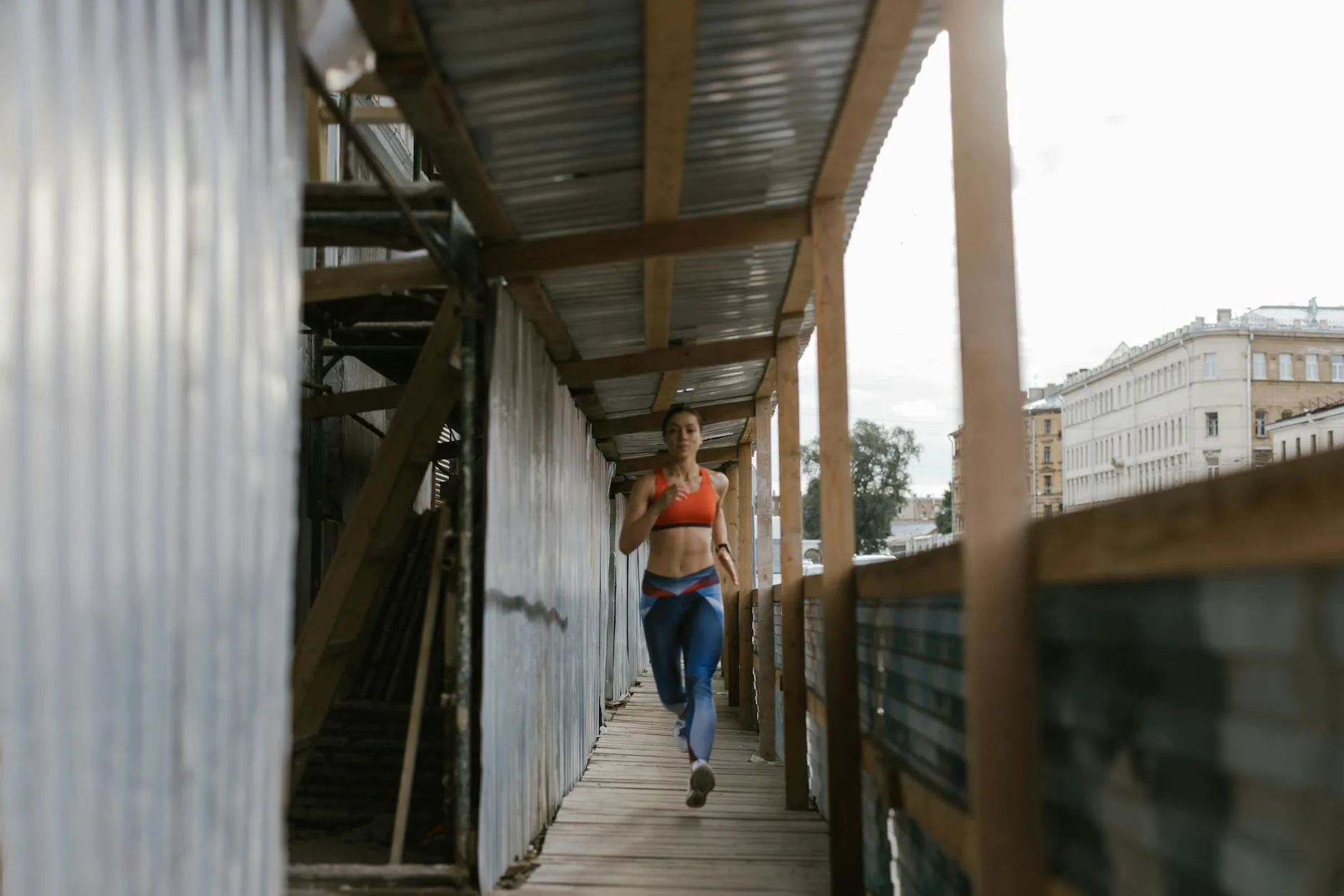 Runner jogging on a scenic trail path during an early morning base building workout