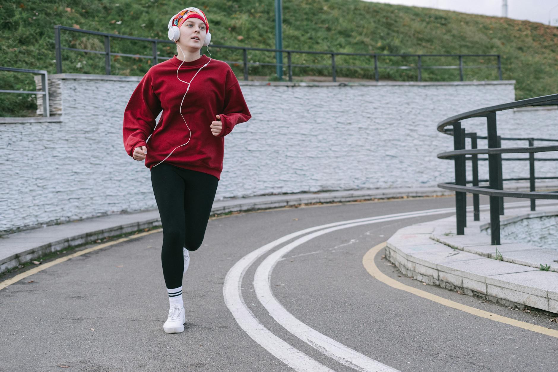 Runner wearing secure wireless earbuds mid-stride on an outdoor trail
