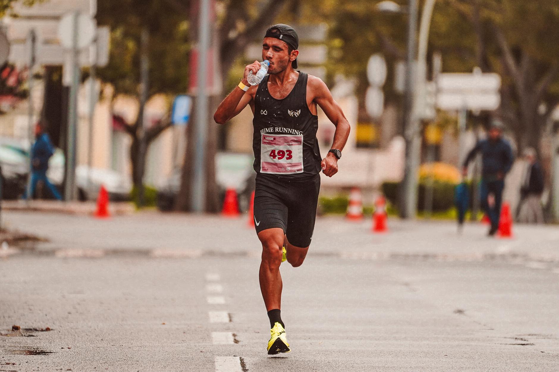 Runner eating pasta meal, carb-loading for marathon race day preparation