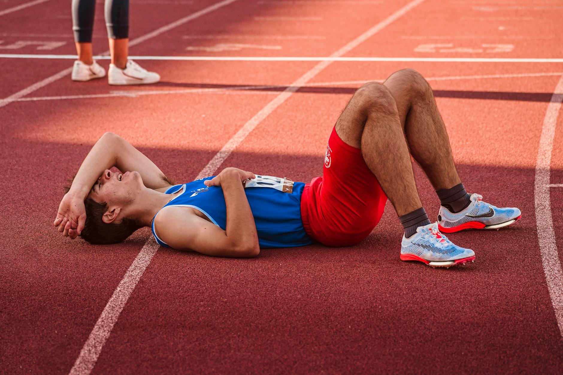 Runner jogging at a relaxed pace on a sunny trail, illustrating easy vs recovery running