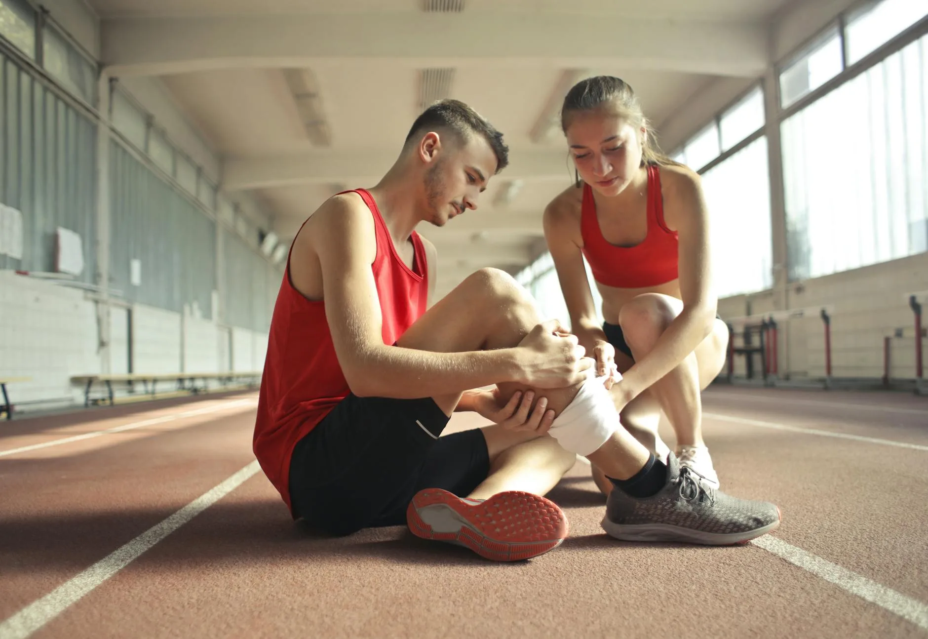 Runner gripping hip in pain during outdoor run, illustrating hip flexor strain