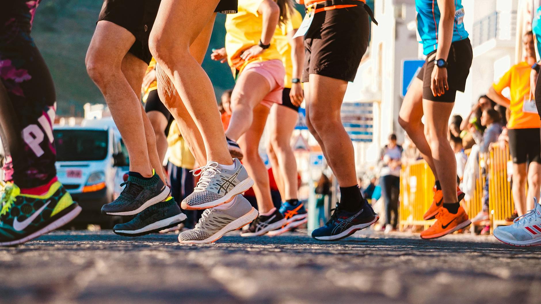 Runner trying on wide-fit running shoes, checking toe box space for proper fit