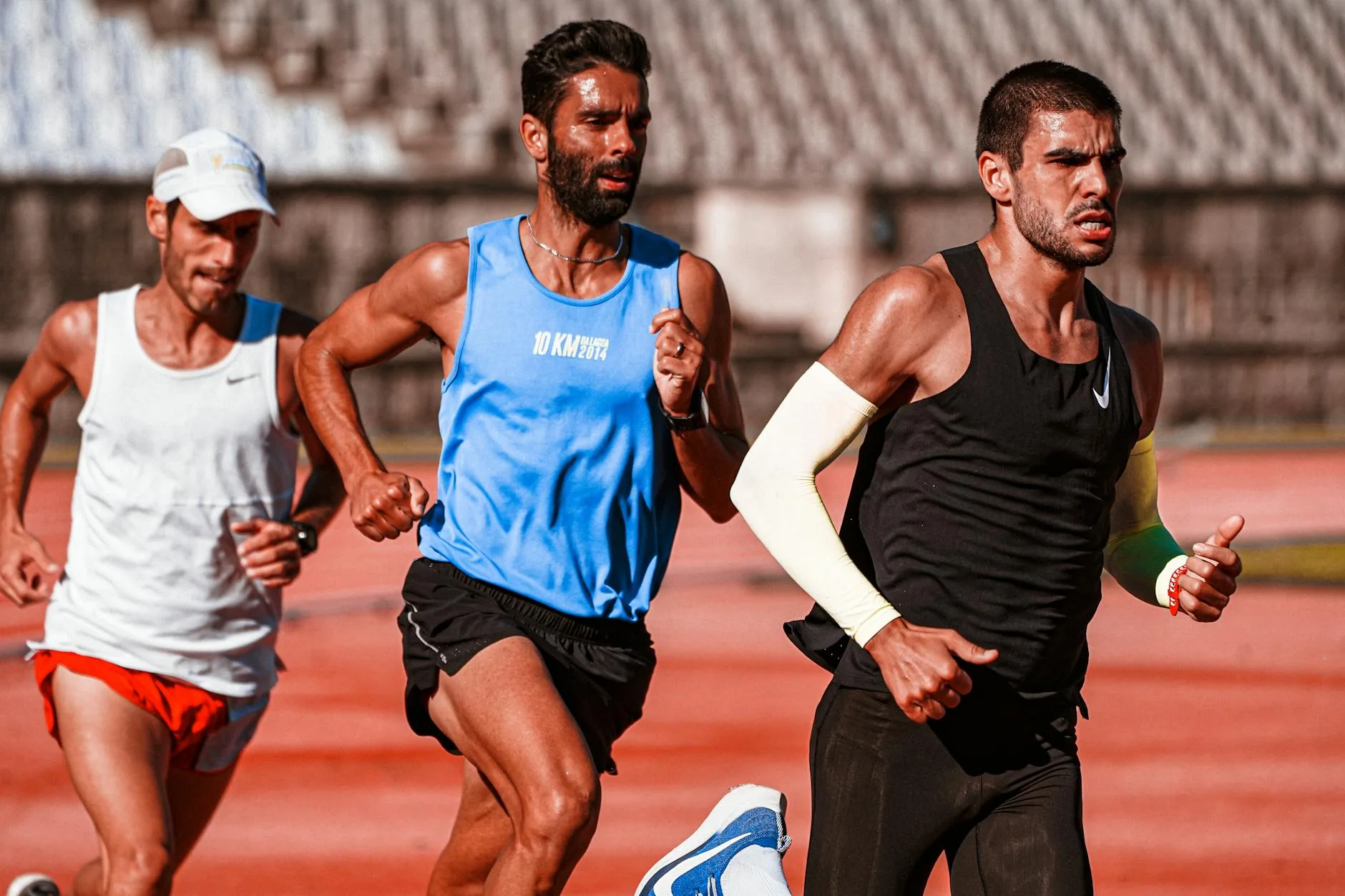 Runner increasing pace on track, demonstrating progressive overload training principles