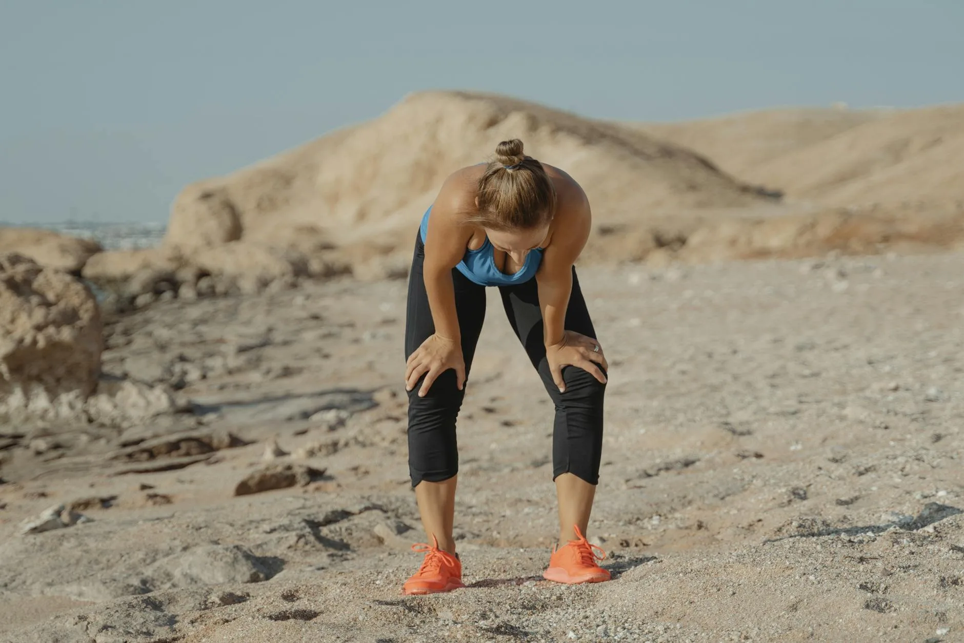 Runner pushing through fatigue on a road, breaking past a training plateau