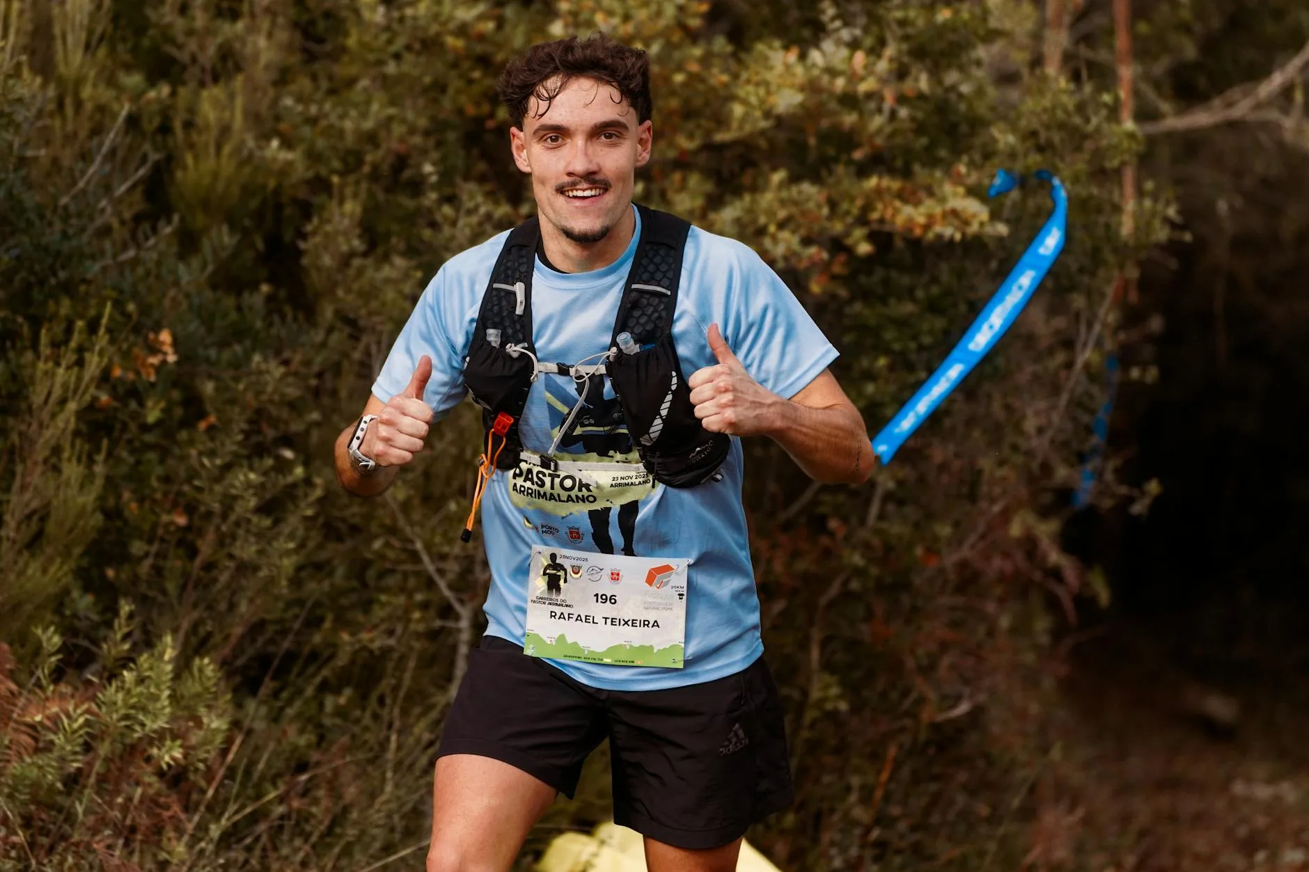 Runner wearing a hydration vest on a trail, comparing it to a waist belt nearby