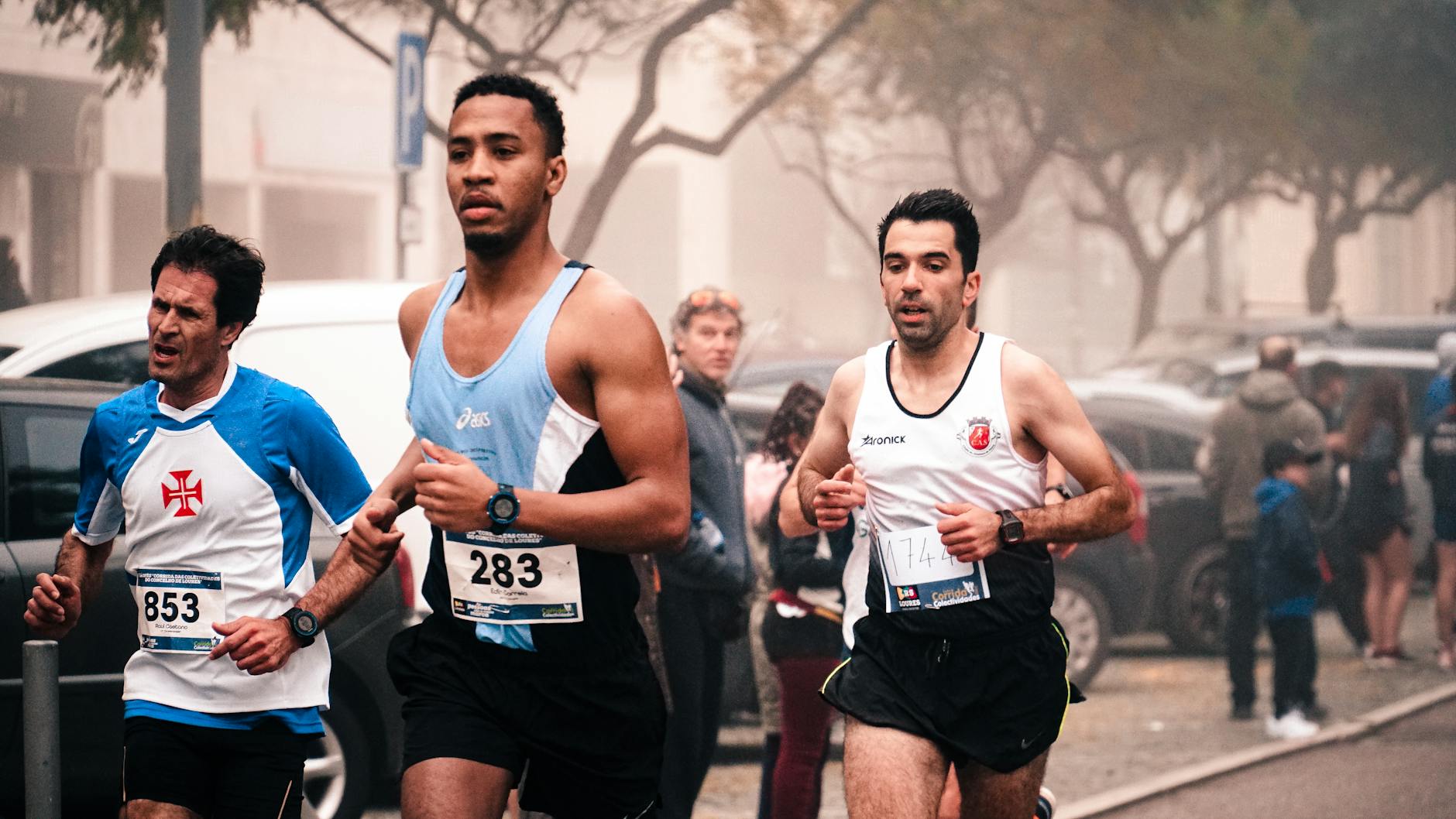 Runner checking a budget GPS sports watch on wrist during outdoor training session