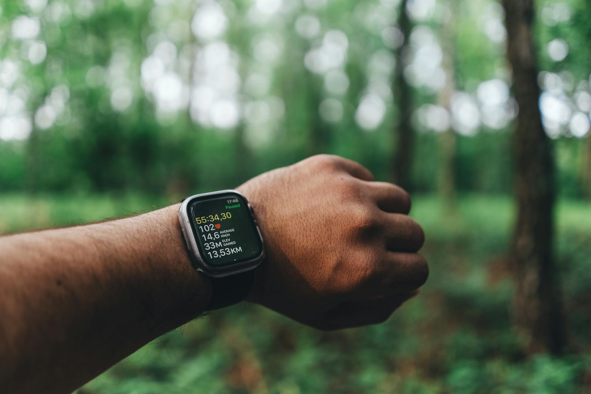 Beginner runner checking heart rate monitor on wrist during outdoor jog