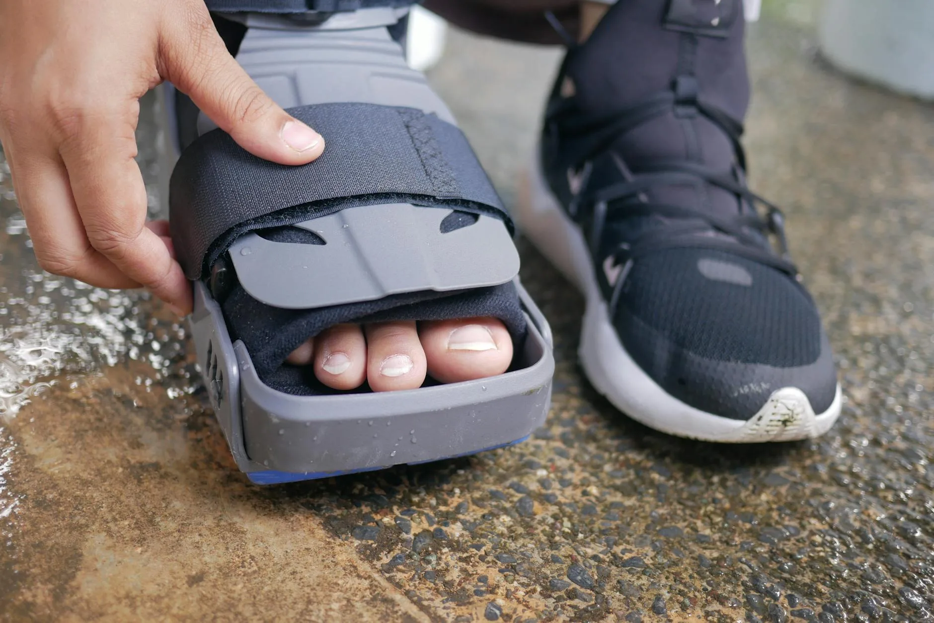 Runner holding injured foot on track, showing stress fracture pain and recovery