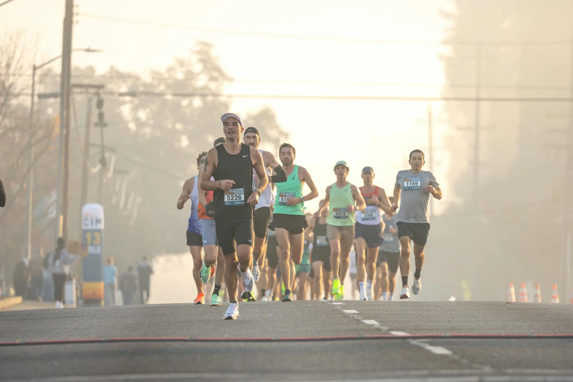 Runner checking training plan and gear laid out for marathon race week preparation