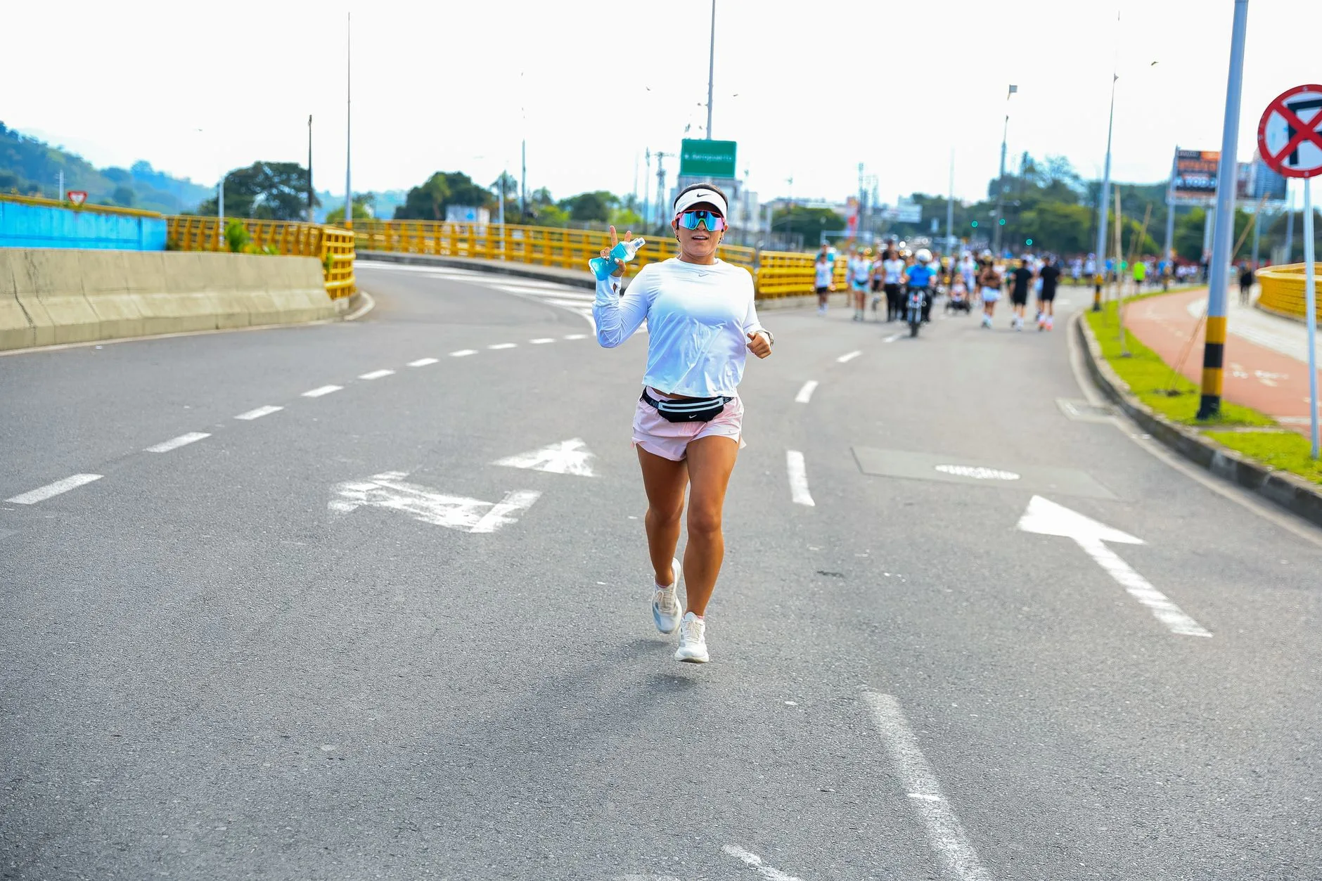 Runner grabbing an energy gel during a UK road race in 2025