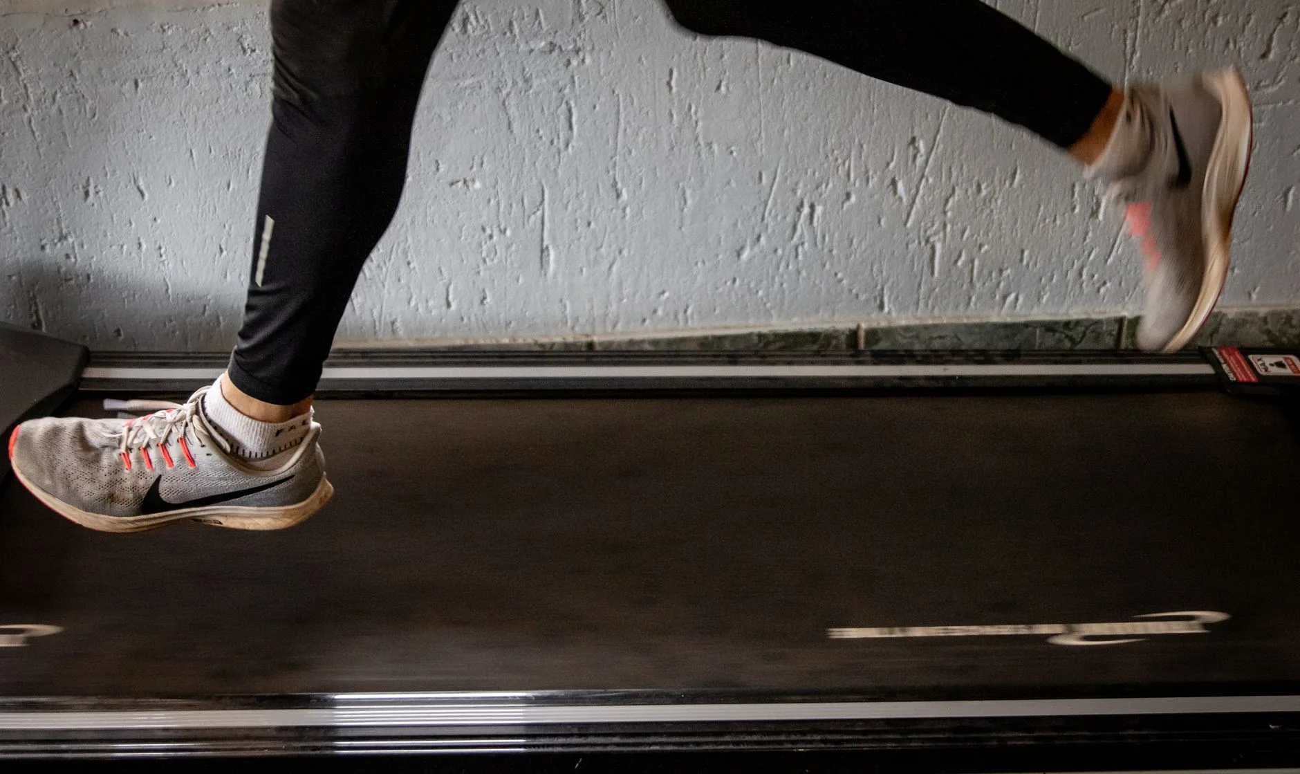 Runner using a budget home treadmill during an indoor workout session