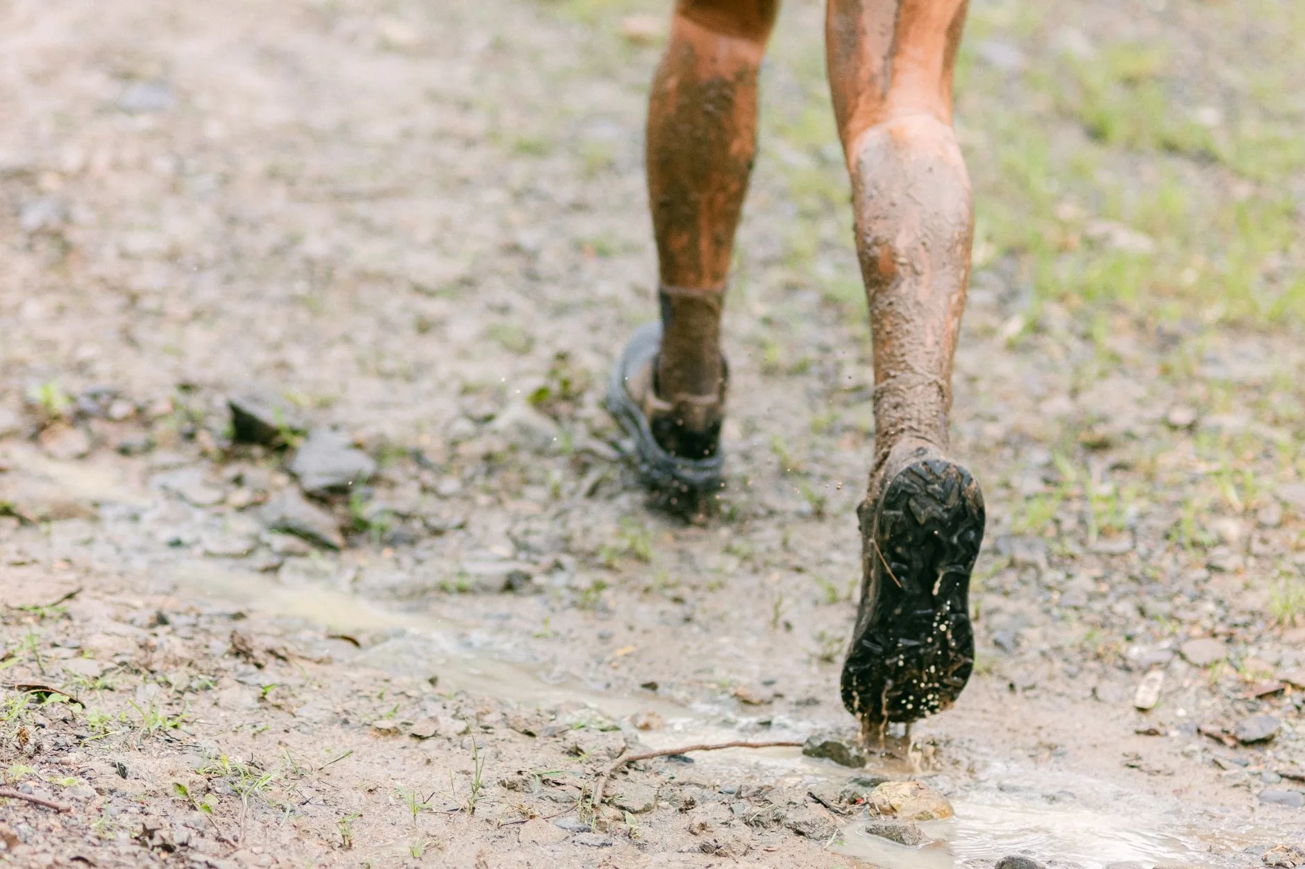 Runner treating a foot blister with bandage after a long run