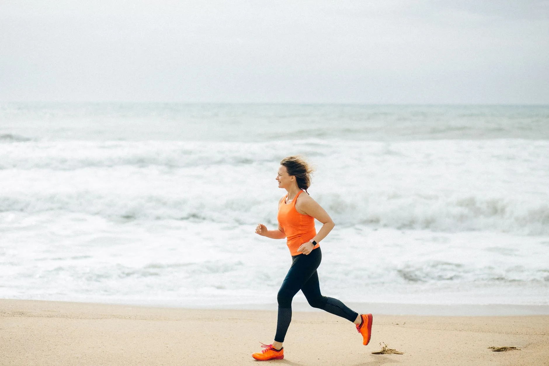 Runner exhaling steadily through mouth on a sunny trail, demonstrating proper breathing technique