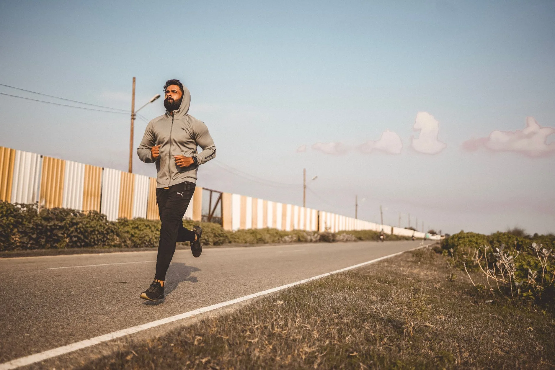 Beginner runner sprinting on track, focused on improving speed and form