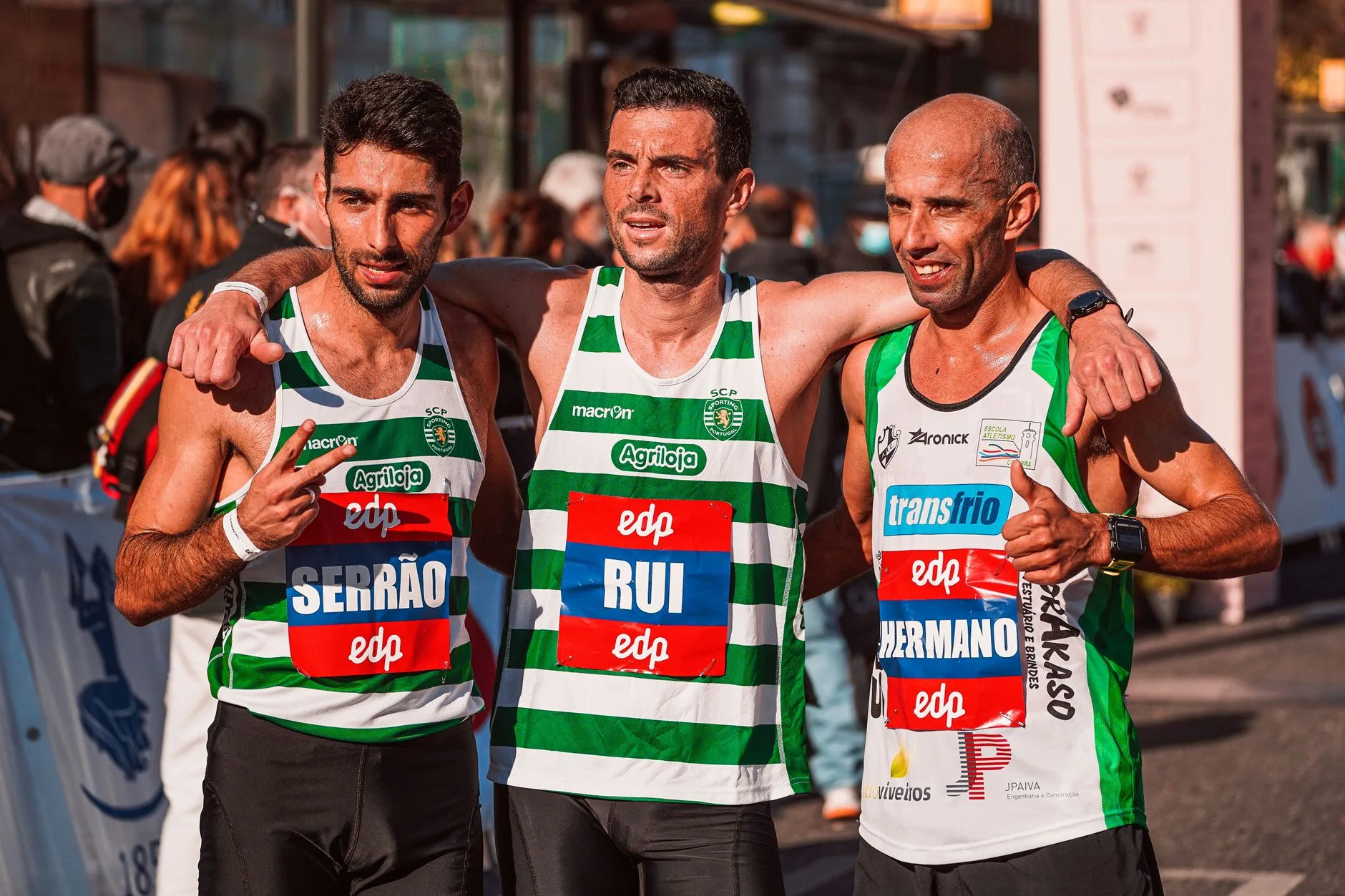 Exhausted marathon runner sitting alone on curb after crossing finish line, medal around neck