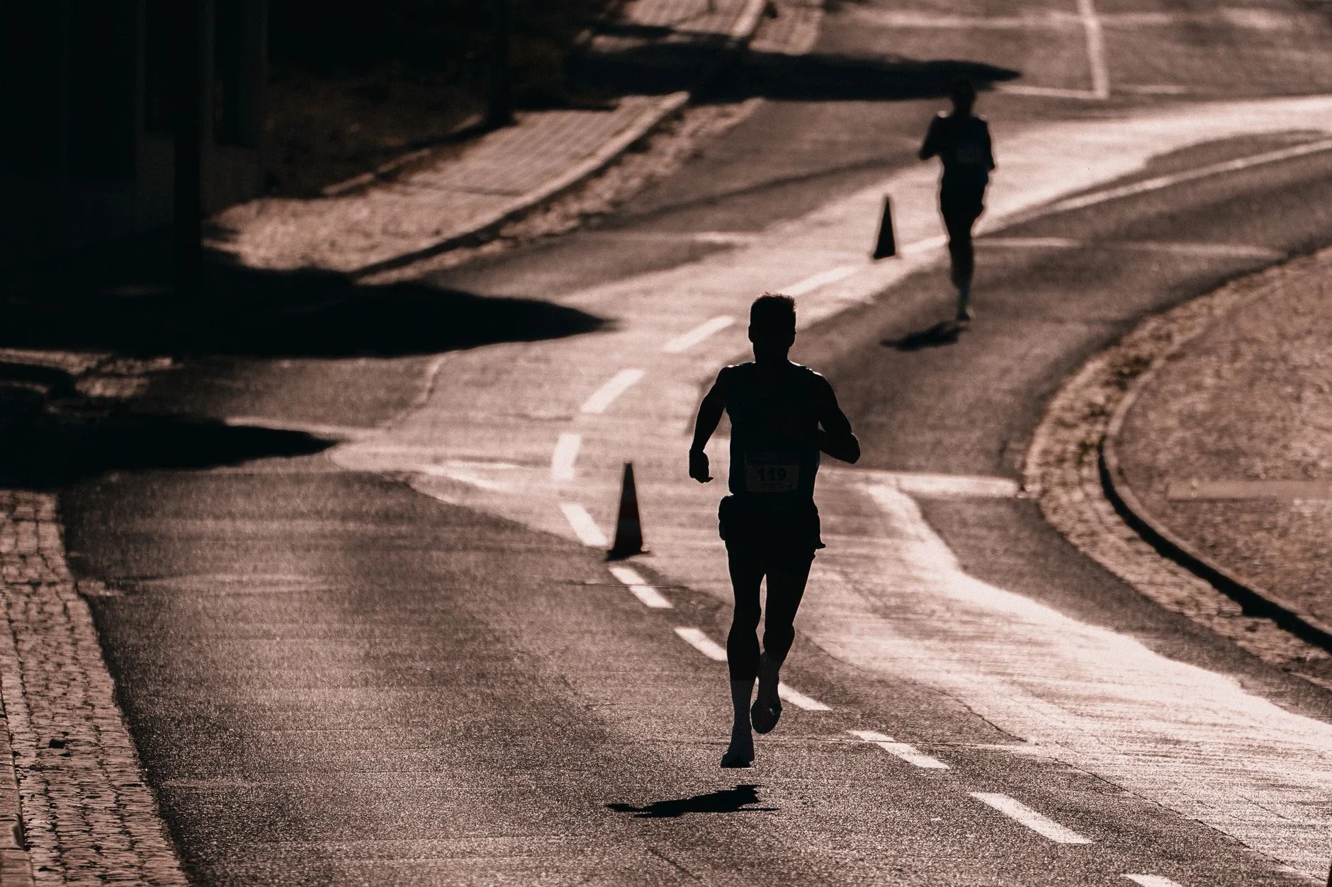 Runner stretching at sunrise before an early morning jog along a quiet path