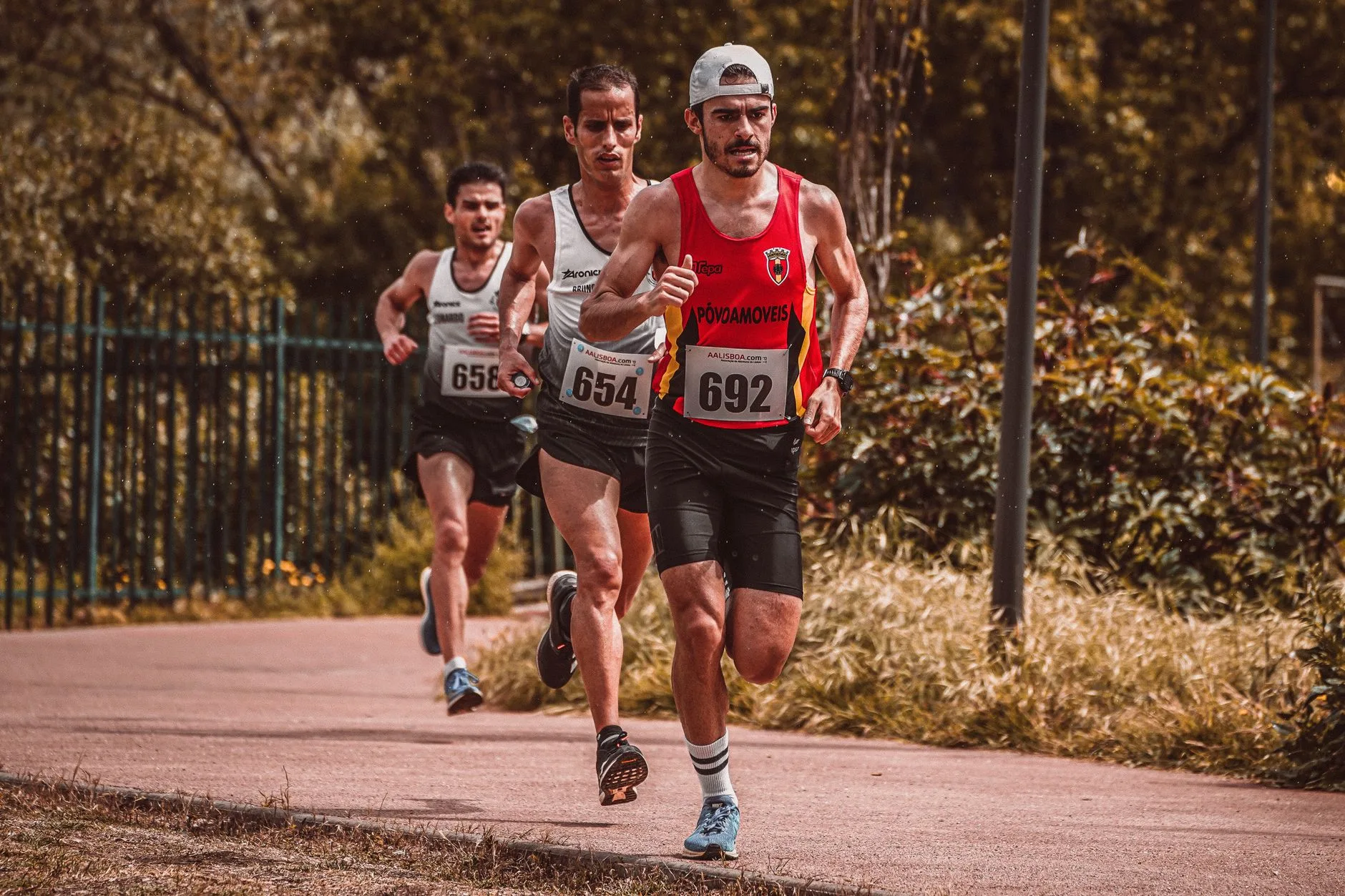 Amateur runner maintaining steady pace during lactate threshold training on a road