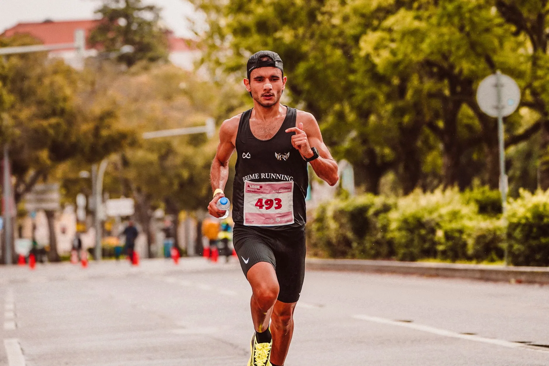 Runner lacing up shoes early morning before work, balancing marathon training with job