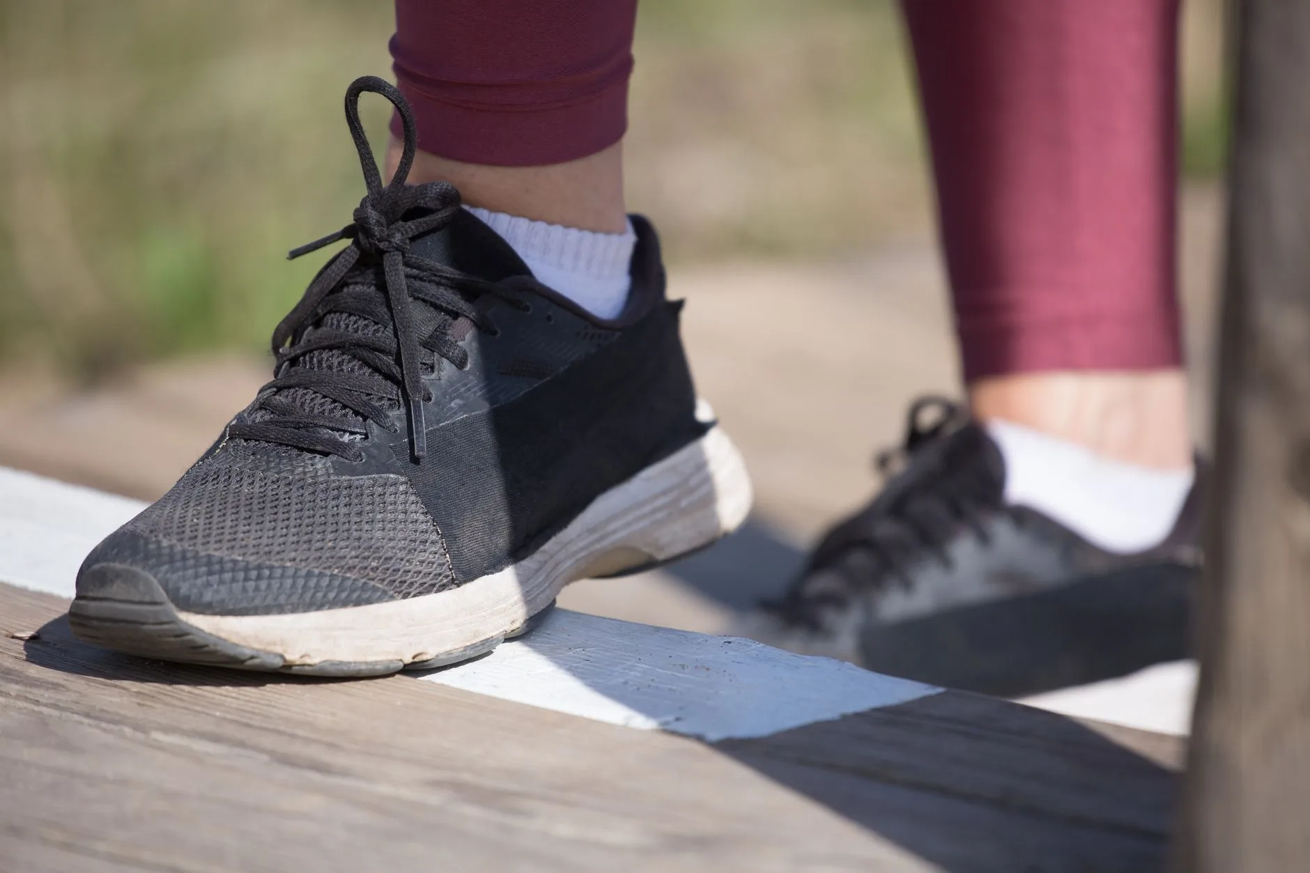Runner jogging on a trail path, gradually building pace during injury recovery