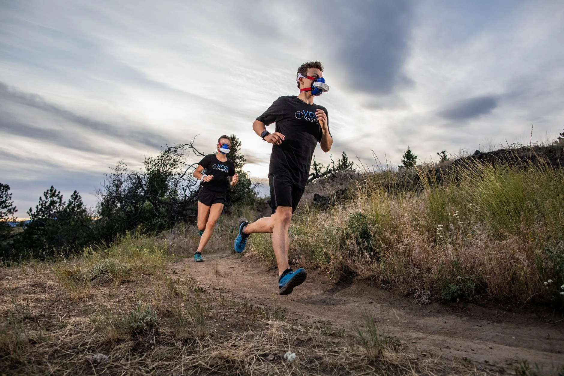 Runner sprinting on a trail, breathing hard while training to boost VO2 max endurance