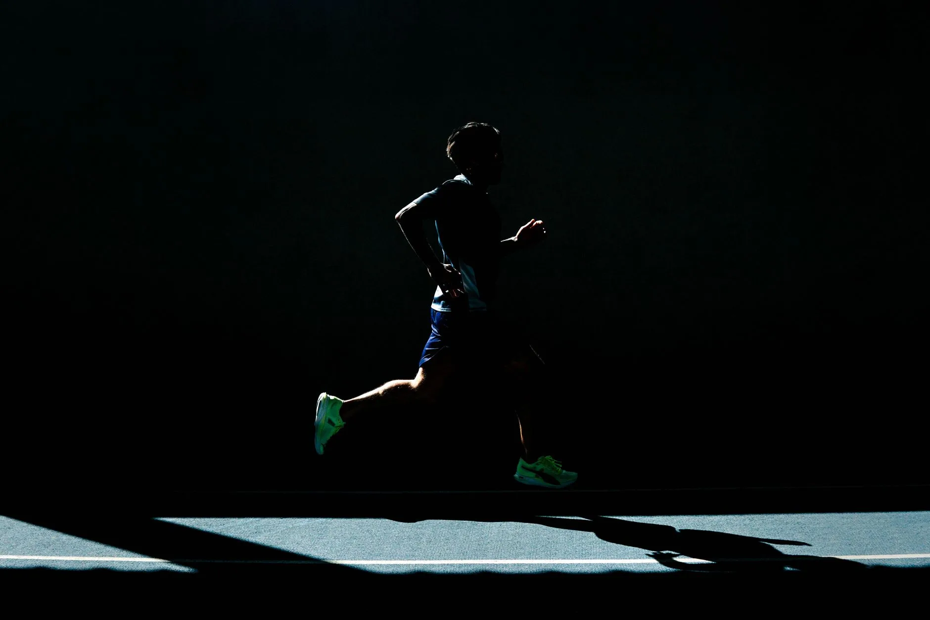 Runner clutching side with cramp pain while jogging outdoors
