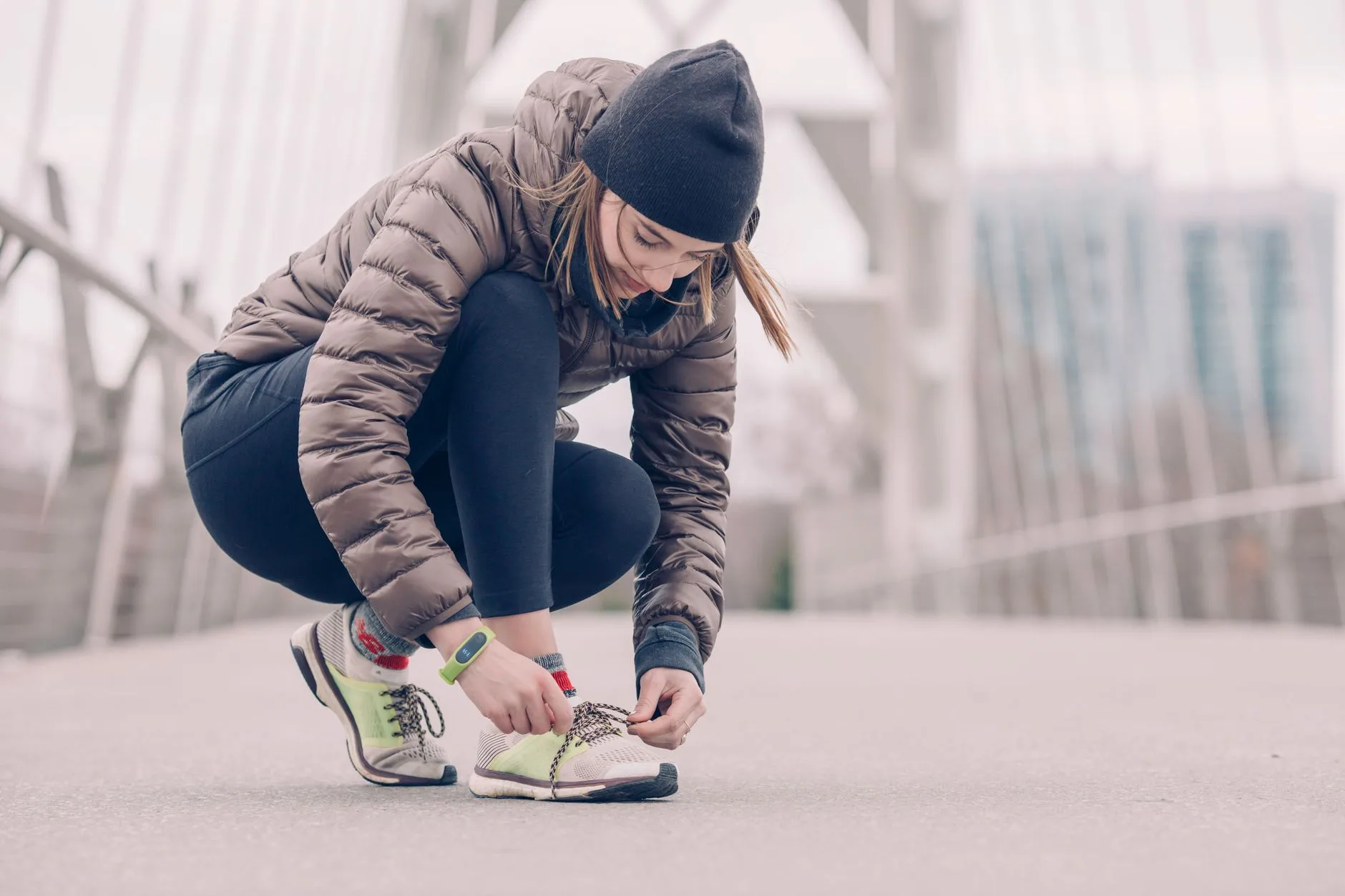 Runner in layered thermal gear jogging along a frosty UK trail in winter