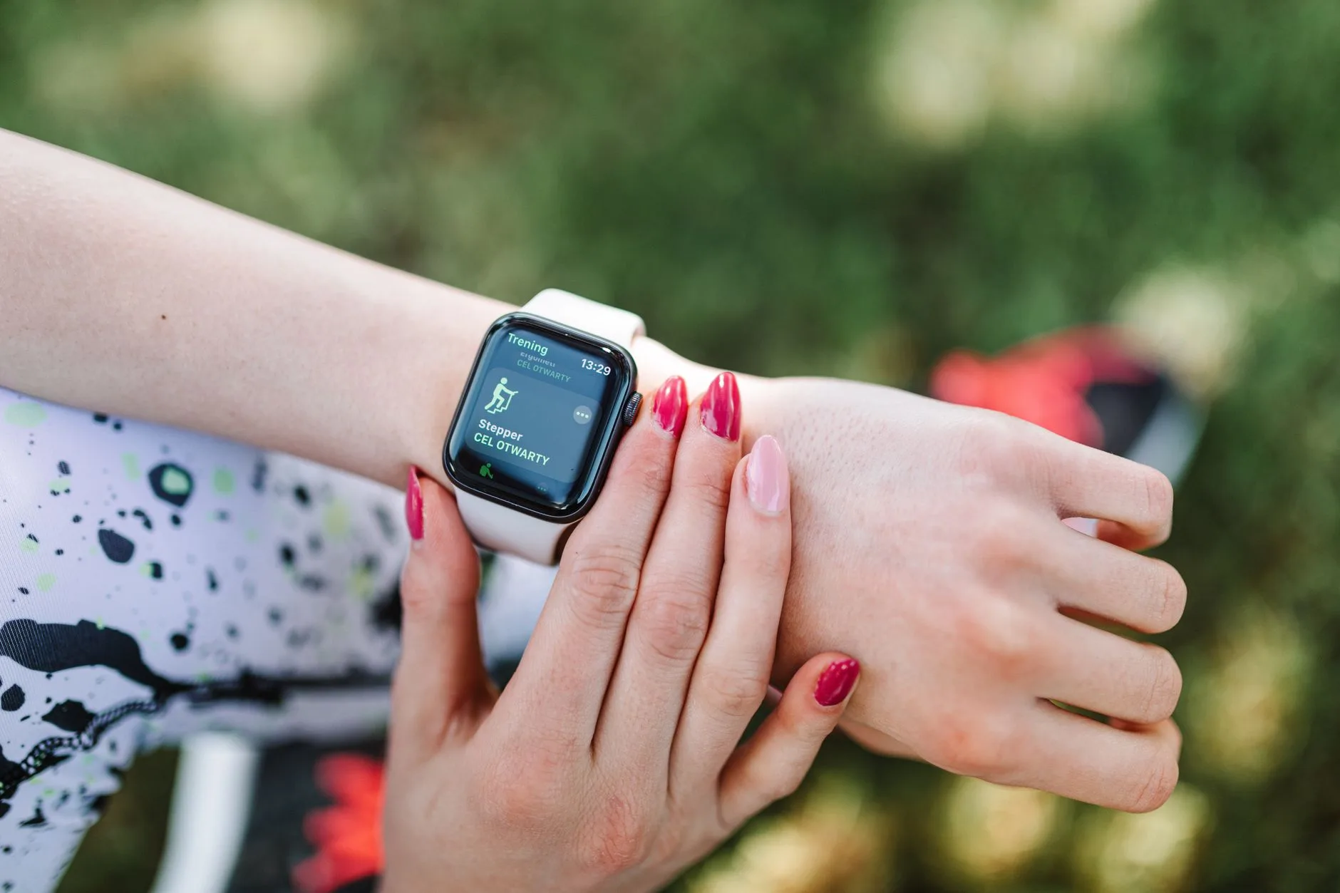 Runner checking data on a wrist running watch during an outdoor training session
