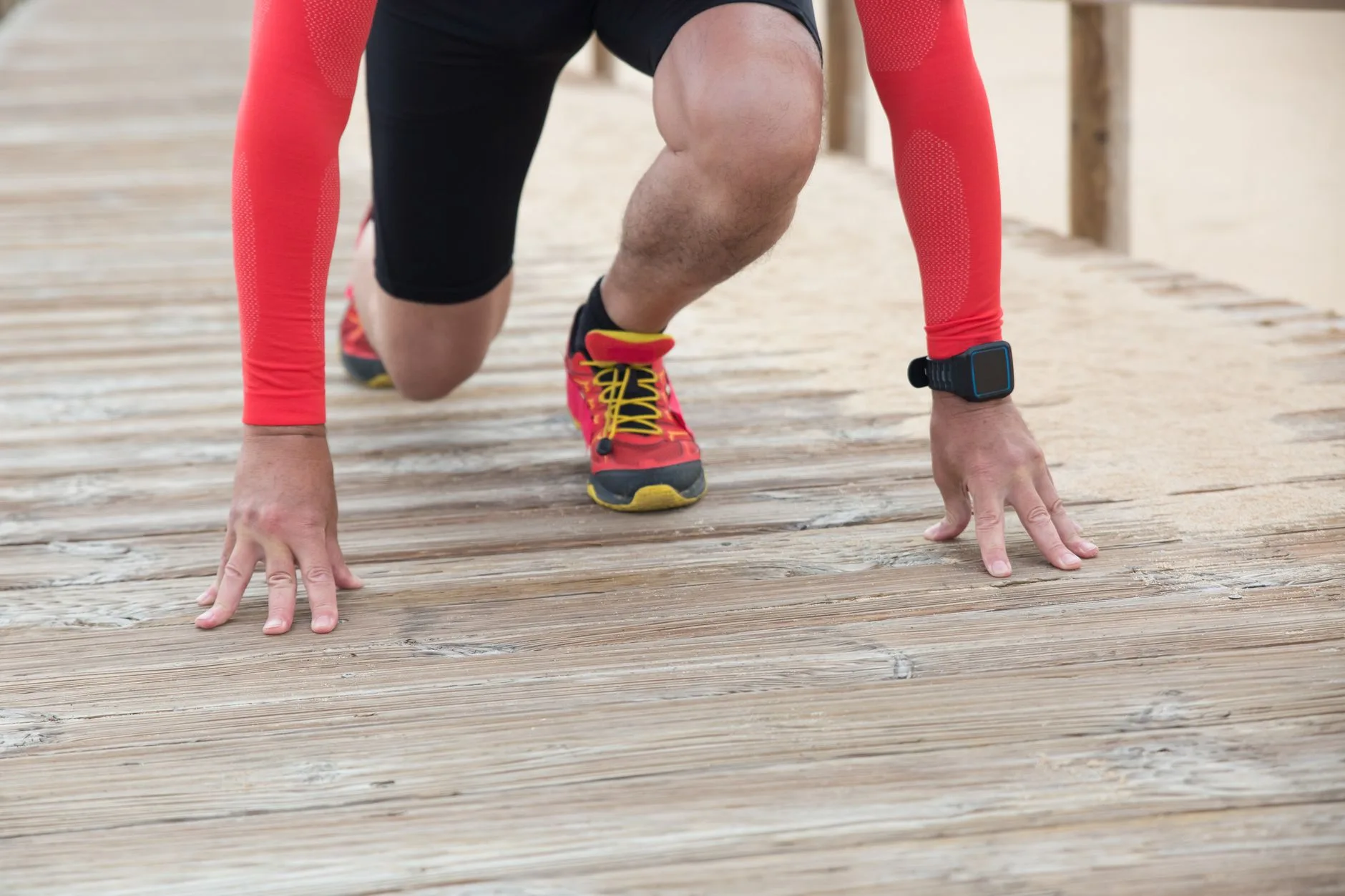 Beginner runner sprinting on a track during an interval speed workout session