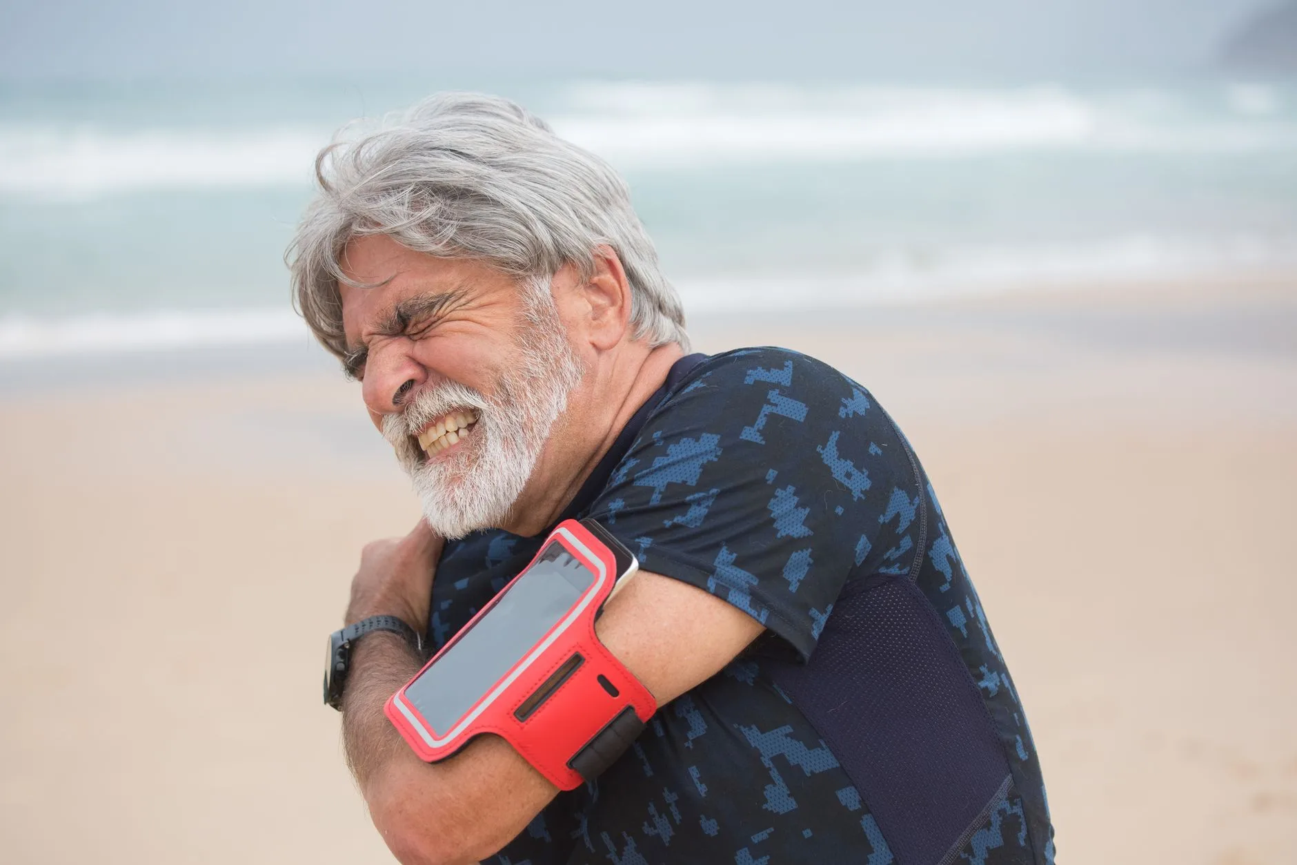 Middle-aged runner jogging on a trail, smiling while staying active and injury-free